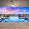 Rooftop Infinity Pool with Lounge Seating at Sunset