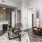 Spacious and well lit living room with wood floors and an open floor plan with access to the kitchen.
