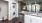 Spacious and well lit kitchen with wood floors and stainless steel appliances. 