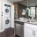 Spacious and well lit kitchen with wood floors and stainless steel appliances. 